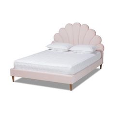 a bed with a pink shell shaped headboard and foot board on top of it