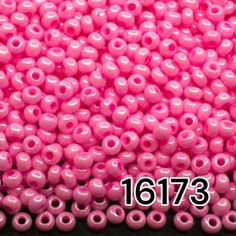 pink plastic beads with holes in the middle on a black background, labeled 10173