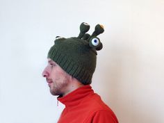 Knitted alien hat. This strange and funny hat is made with a high quality soft lambswool and acrylic blend of yarn. It is very warm and will be a great accent to your winter apparel. Bold and crazy design to bring you good vibes in the cold weather outside. If you are keen on winter activities and you are not afraid to stand out of the crowd, this crazy hat is exactly for you! The yarn is very soft and not itchy but if you have any concerns about the wool content, just contact me, and I will kni Novelty Brimmed Hat Gift, Knitted Novelty Hats, One Size Fits Most, Novelty Green Beanie Hat, Green Novelty Hat As A Gift, Green Novelty Hat As Gift, Green Novelty Hat For Gift, Playful Knitted Hats For Gift, Eyes Monster, Alien Hat