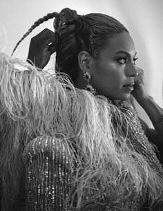 a black and white photo of a woman with her hair in a pony tail braid