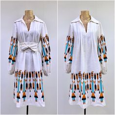 * Southwestern dress c 1970s * Below knee length  * Natural cotton muslin fabric * Large print of Navajo Yei dancers holding arrows on sleeves and above hem * Open V-neck with large pointed collar * Upper bodice is tuck-pleated * Long, set-in Bishop sleeves have snap closure at wrist * Separate self-belt with long ties * Goes on over the head ** Yei is the Navajo name for a deity or a holy one. Yei dancers impersonate the Yei gods on the last day of a ritual or ceremony. The Yeis are usually depicted with long bodies and skirts and hold sacred plants or symbols such as arrows. Yeis are mostly depicted as female with square heads. ** No label. Most likely handmade. Very good condition. Some discoloration under the arms. I have spot-cleaned these areas with no luck in removing the yellowing. Muslin Fabric, Cotton Muslin, Boho Festival, Festival Dress, Muslin Cotton, Dress C, Dress Clothes For Women, Vintage 1970s, Cotton Dress