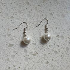 These Pearl earrings are made of plastic imitation pearls and metal hardware. They are perfect for any occasion. Cheap White Pearl Clip-on Earrings, White Clip-on Metal Pearl Earrings, White Pearl Shell-shaped Earrings, 14k Gold-filled Pearl Drop Earrings In Pearl White, Classic Pearl Earrings, Peach Pit, Beer Bottle Cap, 14k Gold-filled Pearl White Earrings With Pearl Charm, Buffalo Nickel