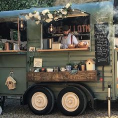 the food truck is decorated with flowers and greenery