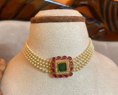 Discover timeless elegance with this Gold Plated Bollywood Necklace Choker Set. Adorned with green pearls, dazzling CZ stones, elegant white pearls, and striking ruby stones in a traditional Jadau Kundan setting, this set is perfect for adding a touch of glamour to any occasion. Handcrafted with care, each piece showcases intricate craftsmanship and a luxurious gold plating finish. Whether for a wedding, party, or special event, this set promises to elevate your style with its vibrant colors and Bollywood Necklace, Kundan Jewellery Set, Kundan Jewelry, Choker Set, Green Pearls, Ruby Stone, Kundan Jewellery, Necklace Choker, Bollywood Fashion