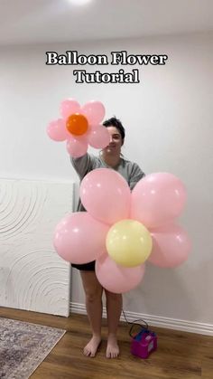 a woman standing in front of a wall with balloons attached to her legs and the caption balloon flower