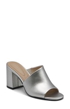 An asymmetrical strap creates a unique touch on this classic open toe mule. 3.5" heel Open toe Asymmetrical vamp Slip-on Block heel Manmade upper, lining, and sole Imported Party Slip-on Mules With Heel Loop, Modern Open Toe Sandals With 4-inch Heel, Elegant Slip-on Heels For Spring, Modern Open Toe Mules With 4-inch Heel, Classic Slip-on Mules For Party, Formal Open Toe Mules With 4-inch Heel, Elegant Open Toe Mules With Sculpted Heel, Modern 4-inch Heels For Spring, Classic 4-inch Heels For Summer