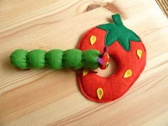 the very hungry caterpillar is hanging on the wooden table with it's teeth