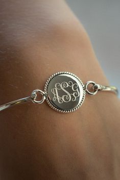 "This monogram sterling silver bangle is in the popular nautical rope style. It makes a beautiful present for your wife, mother or friend (or for yourself!). The center disc will be permanently engraved with a monogram or name. Specify your font choice and initials or monogram for the disc. They are also perfect for for bridesmaids presents. Comes in nice kraft gift box. Shown with the Interlocking Monogram (First, Larger Last, Middle order). Bracelet- Sterling Silver Bangle, 7\" Matching Neckla Monogram Bracelet, Silver Monogram, Nautical Rope, Sterling Silver Bangle, Monogram Jewelry, Stacked Bangles, Silver Jewels, Monogram Necklace, Necklace Boho