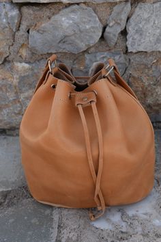 "Handmade Real Leather Bucket Bag in natural biege color Dimensions the bags: Height: 30.0cm (11.8\") Base: 29.0 x 17.0cm (11.4\" x 6.7\") Max. Strap Length: 127.0cm (50\") All Bags are made to order. If you like this bag, please see our full collection in the below link: https://www.etsy.com/shop/madammeshushusection_id=17490770&ref=shopsection_leftnav_3 Dear Visitor Welcome to my store where you will find simple, comfortable and absolutely stylish Greek Summer Sandals and colourful handbag Natural Hobo Bag With Removable Pouch For Everyday, Leather Bucket Satchel With Leather Handles, Leather Shoulder Bag In Bucket Shape For Daily Use, Leather Shoulder Bag For Daily Use In Bucket Shape, Light Brown Satchel Bucket Bag For Everyday, Light Brown Bucket Shoulder Bag For Daily Use, Beige Soft Leather Bucket Satchel, Natural Pouch Shoulder Bag For Daily Use, Light Brown Everyday Bucket Shoulder Bag