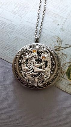 Star Goddess Necklace  The Locket is made with a lot of detailed work and makes a lovely gift ☻About the Locket ~ Can also be used as a small Pill box ~ See Photos for size comparison against American quarter Chain: ~ Antique Silver  YOU CHOOSE YOUR CHAIN LENGTH during checkout ☻More Lockets Here: https://www.etsy.com/shop/FashionCrashJewelry/search?search_query=lockets&order=date_desc&view_type=gallery&ref=shop_search ☻Link to The ENTIRE SHOP: https://www.etsy.com/shop/FashionCrashJewelry?ref=s Magical Star-shaped Jewelry For Gifts, Magical Star-shaped Jewelry Gift, Spiritual Metal Locket Necklace For Gifts, Celestial Style Locket Jewelry Gift, Magical Metal Jewelry As A Gift, Magical Metal Jewelry Gift, Celestial Locket Necklaces For Gifts, Celestial Locket Necklace For Gifts, Spiritual Antique Silver Locket Necklace Gift