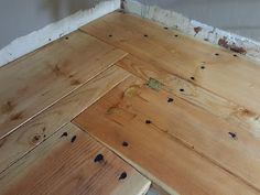 wood flooring being installed in the corner of a room