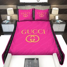 a pink bed with gucci logo on the comforter and matching pillowcases