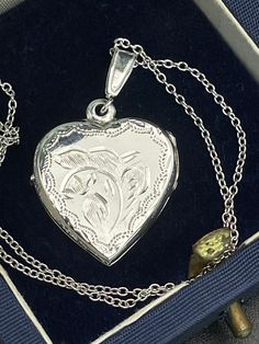 Vintage  silver locket for women. Double sided silver locket with hand engraved back and front. Double photo locket.   Silver heart locket. Silver pendant . Silver necklace for women.        Condition: necklace in perfect vintage condition. Materials: Silver. Rhodium plated silver chain.  Measure: chain 16"/ 41 cm,   Locket  0.7" x 0.7"/  1.8 x 1.8 cm. Package: gift wrap available, please specify when ordering. Delivery: your order will be send by Royal Mail with tracking and signed in 1-2 worki Hallmarked Medallion Jewelry For Keepsake, Medallion Jewelry Hallmark Keepsake, Engraved Jewelry Collectible For Valentine's Day, Keepsake Medallion Jewelry With Hallmark, Etched Silver Jewelry For Mother's Day, Mother's Day Silver Locket Jewelry, Silver Locket Jewelry For Mother's Day, Antique Engraved Necklaces For Mother's Day, Hallmarked Locket Necklace As Valentine's Day Gift