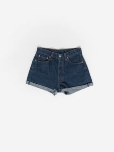 Vintage 90s Levis turn up denim shorts for women. These 1990s indigo blue Levis turn up shorts feature two front pockets, two back pockets, a button fly, the brown Levis patch is on the waist (back right) and the red Levis tab is on the back right pocket. Made in the USA from a mid-weight cotton. Our recommended size: Small Label says: W28 for women Condition: Very good Material: 100% cotton Measurements, laid flat, in inches:  Waist: 28 Inside leg: 2 Outside leg: 12 Front rise: 11 Hip (measured Retro Jean Shorts With Pockets, Classic Medium Wash Short Leg Shorts, Vintage High Waist Dark Wash Shorts, Classic High-waisted Relaxed Fit Jean Shorts, Classic Medium Wash Shorts, Vintage Dark Wash Mid-rise Shorts, Vintage Mid-rise Shorts With Pockets, Vintage Style Mid-rise Dark Wash Shorts, Classic High Waist Jean Shorts For Summer