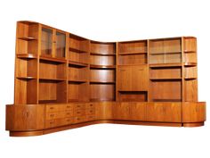 a large wooden bookcase with drawers and shelves on each side, in the shape of a curved corner