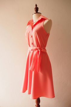 a dress on a mannequin with a pink background