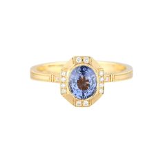 a gold ring with an oval blue and white stone surrounded by small round diamonds on the band