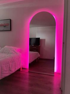 there is a bed with pink lights in the room