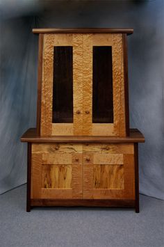 a wooden cabinet with two doors on the front and back sides, made out of wood