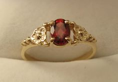 100% Australia Made BRAND  NEW  GENUINE  SOLID  9ct YELLOW GOLD   BEAUTIFULLY CRAFTED NATURAL GARNET DAISY DRESS RING Quality Ring HIGHLY POLISHED crafted with Precision & Detail  Suitable for every day wear and all ages. Will make a wonderful gift GENUINE SOLID GOLD   NOT FILLED   NOT HOLLOW   NOT PLATED   HALLMARKED (Stamped) 9ct Ring Weight : 1.6 grams to 1.8 grams approx. depending on size Ring Width : 6 mm widest point tapering to 1.5 mm Gemstone : Natural Garnet (6x4 oval 0.5ct approx.) Av Garnet Ring Gold, Vintage Gold Rings, Cute Engagement Rings, Solitaire Rings, Daisy Dress, Dress Ring, Birthday Ring, Garnet Jewelry, Dress Rings