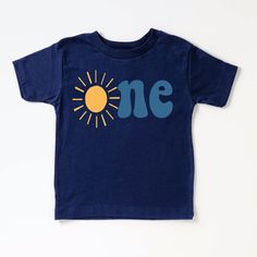 Celebrate your little one's 1st birthday in style with this adorable sun shirt! Perfect for a fun and sunny birthday party, this shirt features a cheerful design that will make your little one stand out. Made with soft and breathable fabric, this shirt is both cute and comfortable for your baby to wear all day long. Add a special touch to your little one's birthday celebration with this 1st birthday sun shirt! + Machine washable & dryer safe (I recommend drying on delicate) + Design color will d Playful Short Sleeve Top For First Birthday, Blue Cotton T-shirt For First Birthday, Fun Blue Top For First Birthday, Playful T-shirt For First Birthday In Spring, Blue Summer T-shirt For First Birthday, Fun Cotton Tops For First Birthday, Yellow Tops For Summer Birthday, Fun Summer T-shirt For First Birthday, Playful Summer Birthday Shirt