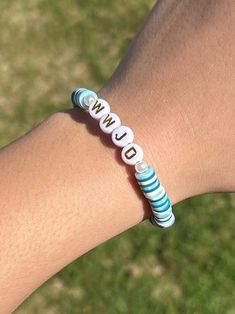 a person's arm with a bracelet on it that says wild written in white letters