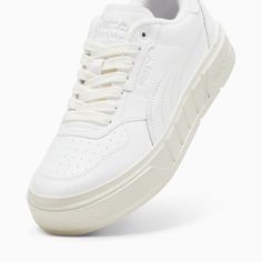 a white sneaker with laces on the side