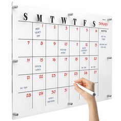 a person writing on a calendar board with the word smtwtfs written on it