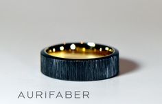 an image of a wedding ring that is black and gold