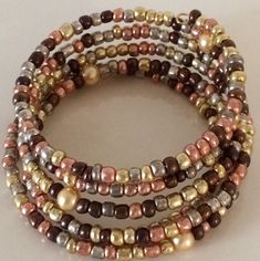 These are beautiful handmade  beaded bracelets which come in an assortment of widths.   Single strand to 8 strands.   Our single strand bracelets are great to wear with your other gold or silver bracelets to give them a touch of color to accent them. The price varies from $10.00 to $25.00. Please contact us for specific price or if you have any questions.  If you prefer a special color or style, we will take special orders. Gold Bohemian Wrap Bracelet With Spacer Beads, Gold Multi-strand Stackable Beaded Bracelets, Gold Wrap Bracelet With Colorful Beads As Gift, Gold Wrap Bracelet With Colorful Beads, Gold Hand-wrapped Beaded Bracelets, Gold Hand Wrapped Beaded Bangle Bracelets, Hand Wrapped Gold Beaded Bangle, Gold Wrap Bracelet With Spacer Beads, Gold Spiritual Beaded Bracelets Hand Wrapped