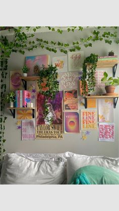 there are many plants on the wall above the bed and in the corner is a shelf with books