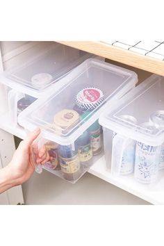 two plastic containers filled with food on top of a shelf