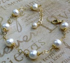 Beautifully polished real freshwater pearls in white create a simple yet elegant bracelet for a June born girl since pearl is her traditional birthstone. Genuine elegant pearls are hand wire wrapped with 14k gold filled wire and finished with a gold filled clasp and chain extender for the perfect fit every time. Give a thoughtful high quality freshwater pearl gift for mom who loves pearls or for your bride who loves dressy  classic pearl jewelry. Gorgeous accessory for a little black dress or a Anniversary Pearl Bracelet, Pearl Drop Bracelet Perfect As A Gift, Classic Pearl White Bracelet For Anniversary, Anniversary Akoya Pearl Bracelet In Pearl White, Gift Pearl Bracelet With Akoya Pearl And Pearl Drop, Akoya Pearl Bracelets With Round Beads For Wedding, Akoya Pearl Bracelet With Pearl Charm As Gift, Akoya Pearl Bracelet With Pearl Chain As Gift, Akoya Pearl Bracelets For Anniversary In Pearl White