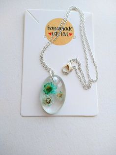 Handmade resin pendant made with real turquoise & cream dried flowers The pendant is handmade with  Small turquoise and cream dried flowers set in crystal clear resin. 3cm Handmade Resin Charm 40cm Silver Plated Chain Each Resin piece I make is a unique true handmade one of a kind, the resin is incredibly light to wear and durable for everyday use. The best way to look after your resin jewellery is to avoid to much contact with water as this can cause some discoloration to the resin, your jewell Turquoise Flower Necklaces For Gift, Turquoise Jewelry With Natural Inclusions For Gifts, Turquoise Jewelry With Flower Charm For Gift, Turquoise Jewelry With Flower Charm As Gift, Turquoise Resin Jewelry As Gift, Turquoise Resin Jewelry For Gift, Handmade Minimalist Clear Necklace, Minimalist Silver Resin Jewelry, Handmade Resin Flower Pendant Necklace