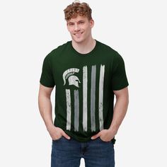 You wave your team flag high on gameday. Now you can wear it too! Look good, feel good, and get ready to let everyone know that you’re the MVP of fan fashion with the Michigan State Spartans Brushstroke Flag T-Shirt. This top features a design that showcases your all-important team colors, a team logo display, and a team-colored brushstroke flag display meaning this t-shirt will prove your unmatched dedication to the Michigan State Spartans when you’re at the game or watching at home with your f Flag Display, Fan Fashion, Logo Display, Michigan State Spartans, Look Good Feel Good, One Piece Pajamas, Team T Shirts, Flag Tshirt, Team Shirts