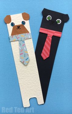 two paper cut out dogs with ties on them, one is black and the other is white