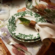 a table set with plates, silverware and napkins