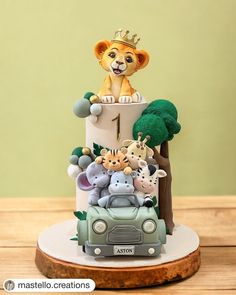 a cake decorated with animals and a crown on top