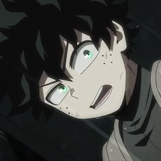 an anime character with green eyes and black hair looking up at the camera from behind