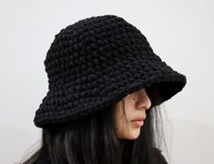 a woman wearing a black crocheted hat