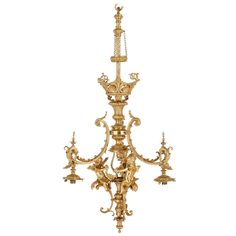 a gold chandelier with four lights hanging from it's sides and an ornate design on the side