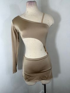 a mannequin wearing a tan top and skirt