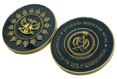 two black and gold medallions with symbols on them