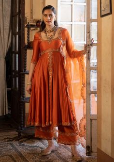 Paulmi & Harsh-Burnt Orange Anarkali Set-INDIASPOPUP.COM Elegant Anarkali Suits, Ethnic Anarkali Dresses, Tissue Anarkali Dress, Embroidery On Orange Fabric, Tissue Fabric Dress Design, Rust Orange Lehenga, Silk Dresses Indian, Mehndi Gharara, Wedding Guests Outfits