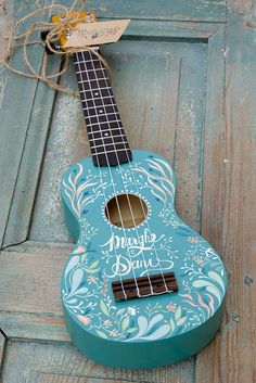 a blue ukulele sitting on top of a wooden floor