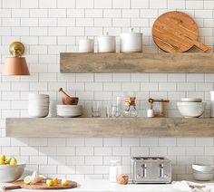 the kitchen is clean and ready to be used for cooking or baking, with white tile on the walls