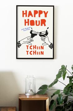 a happy hour poster hangs on the wall next to a table with a plant in it