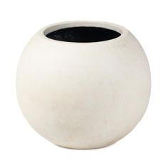 a white vase sitting on top of a table