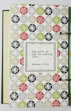 a book with an open page on the front and back cover is decorated with snowflakes