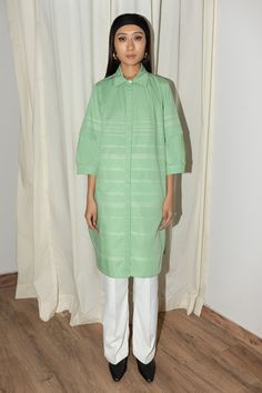 Mint cotton poplin dress with puff sleeves, side pockets, back pleated details, contrast stripe pattern and anchor thread work stitch lines.
Components: 1
Pattern: Embroidered
Type Of Work: Thread Work
Neckline: Band Collar
Sleeve Type: Puff Sleeves
Fabric: 100% Cotton Poplin
Color: Green
Other Details: 
Curved hem
Closure: Front concealed button placket
Note: The pant worn by the model is not for sale
Occasion: Work,Party - Aza Fashions Cotton Dresses With Pleated Sleeves For Daywear, Cotton Long Sleeve Dress With Cuffed Sleeves, Cotton Shirt Dress With Cuffed Sleeves For Spring, Cotton Dresses With Cuffed Sleeves For Daywear, Daywear Shirt Dress With Pintucks, Green Cotton Shirt Dress For Daywear, Green Cotton Midi Length Shirt Dress, Green Cotton Midi Shirt Dress, Shirt Dress For Women